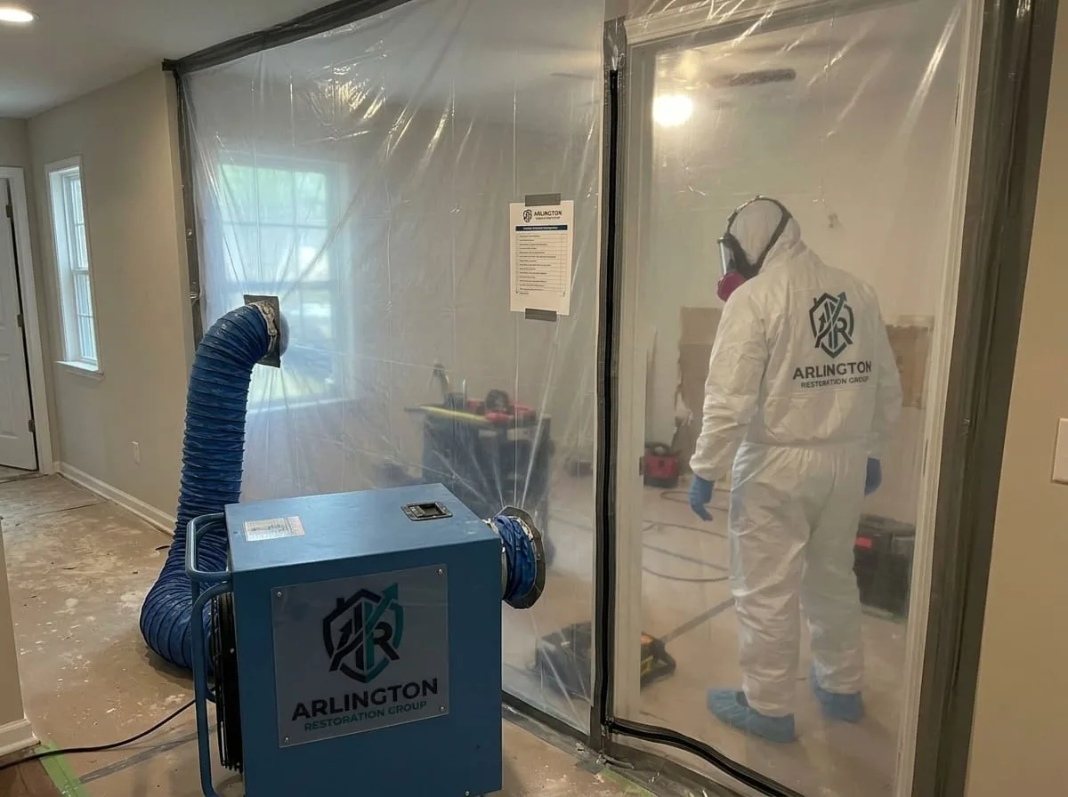 Plastic containment barrier set up around a basement mold remediation work area