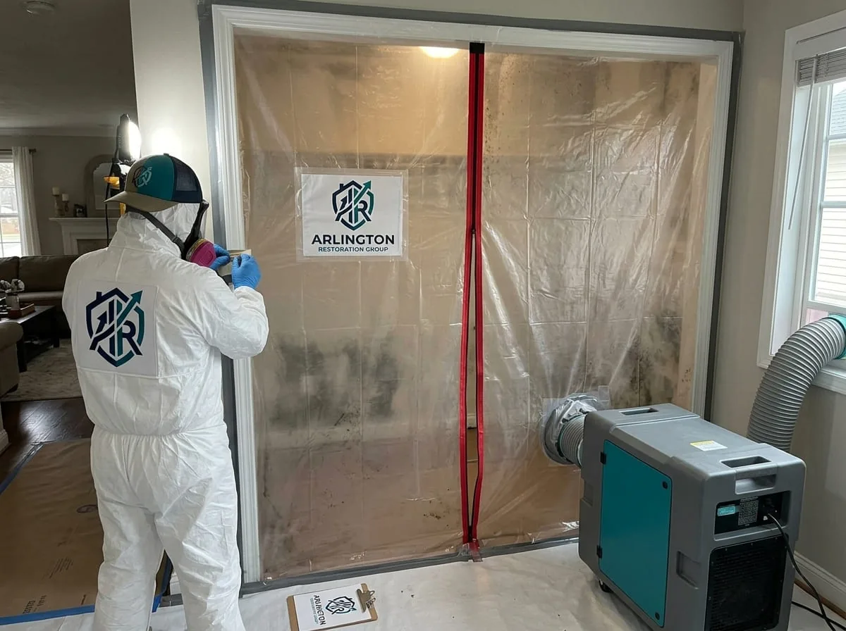 Hazard containment signage posted at the entrance of a mold remediation work zone